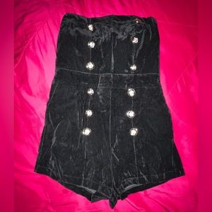 Double breasted black velvet romper.